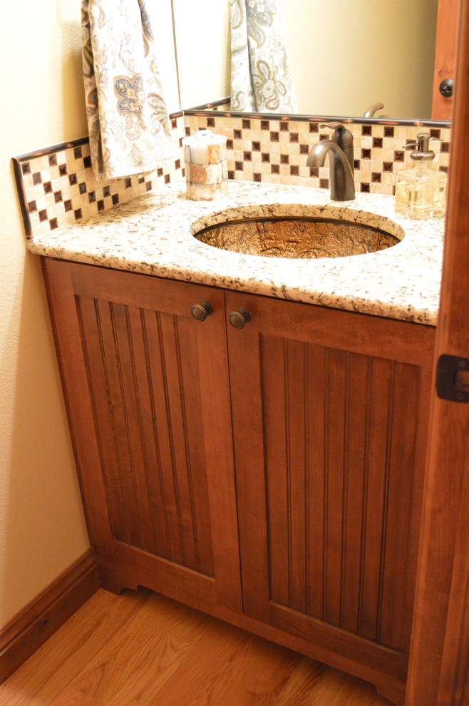 Small cottage powder room photo in Denver with recessed-panel cabinets and medium tone wood cabinets