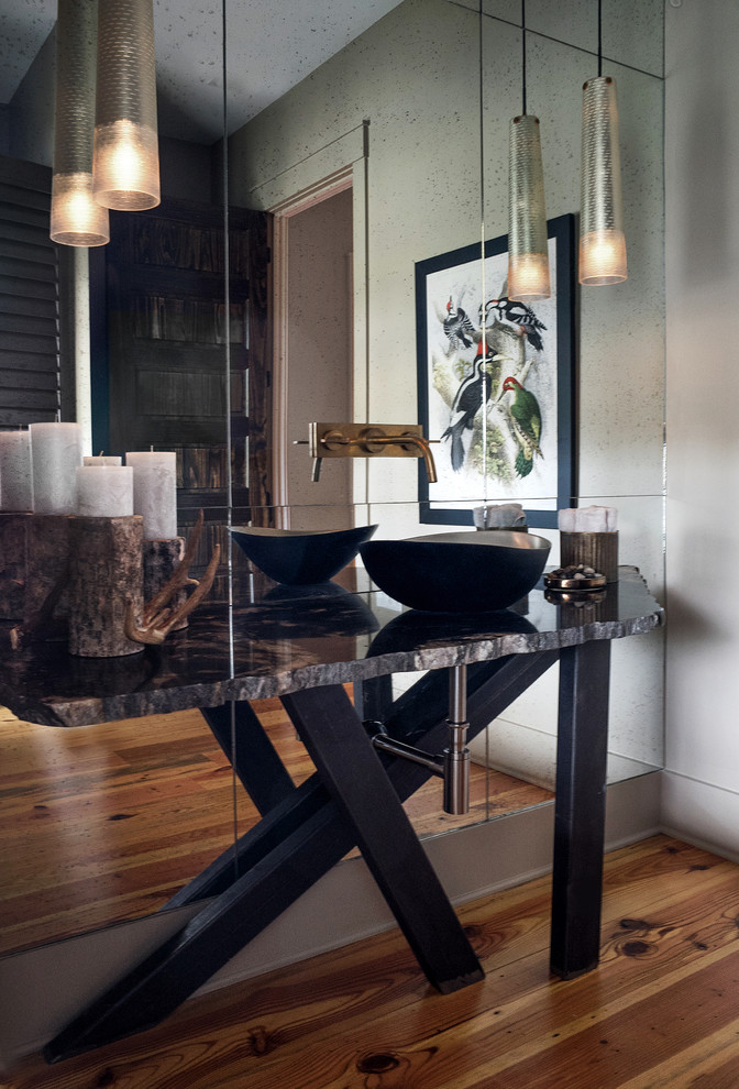 Example of a mid-sized mountain style medium tone wood floor powder room design in Atlanta with a vessel sink