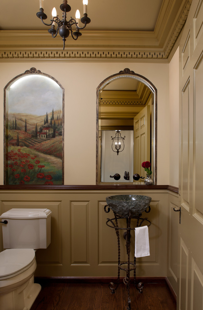 Powder room - small traditional dark wood floor and brown floor powder room idea in Detroit with a two-piece toilet, beige walls, a vessel sink and raised-panel cabinets