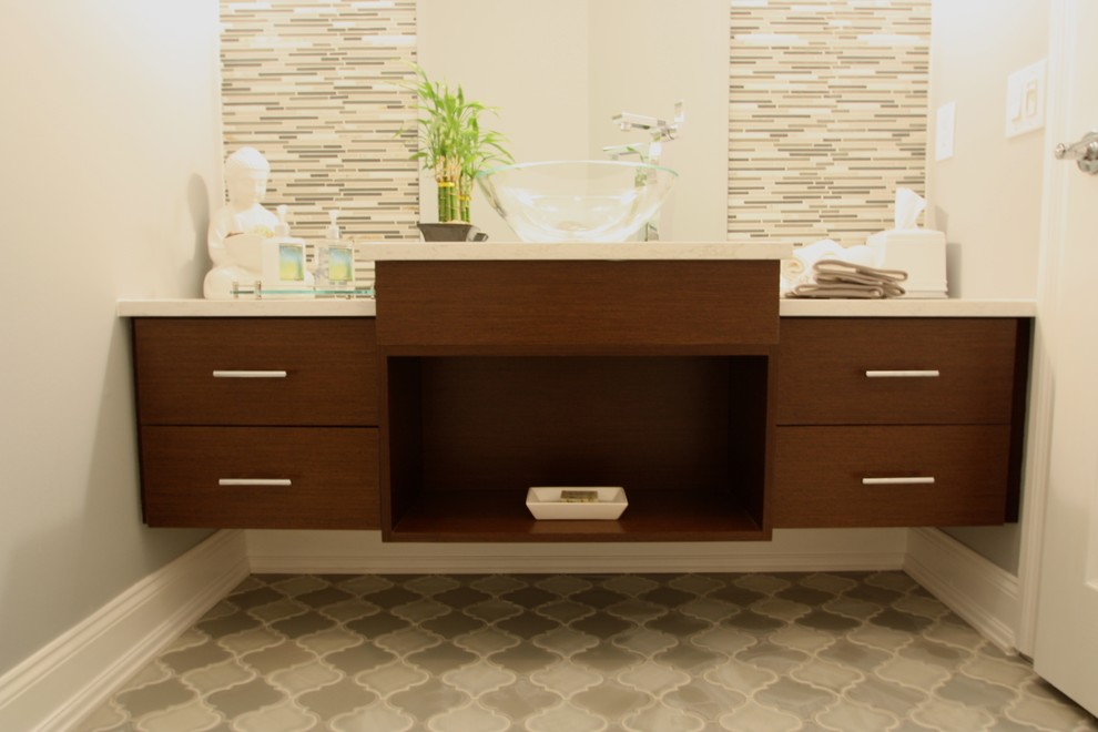 Inspiration for a mid-sized contemporary matchstick tile ceramic tile powder room remodel in New York with flat-panel cabinets, dark wood cabinets, beige walls, a vessel sink and granite countertops