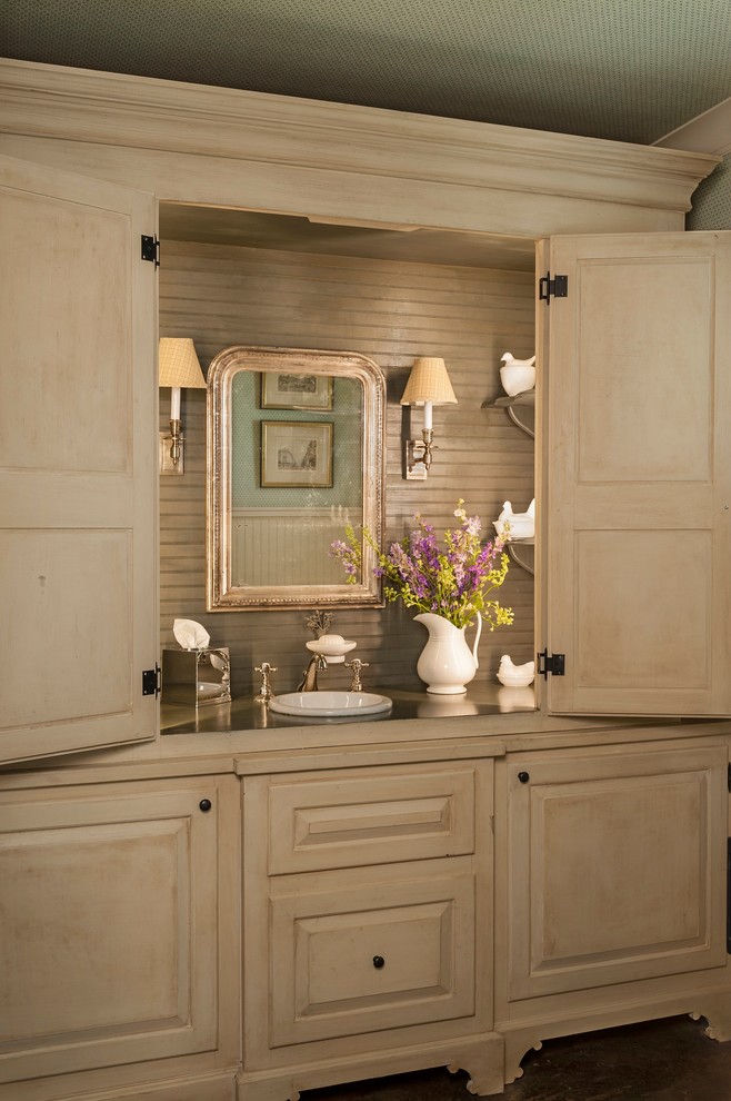Design ideas for a rural cloakroom in Houston with a built-in sink, freestanding cabinets and beige cabinets.
