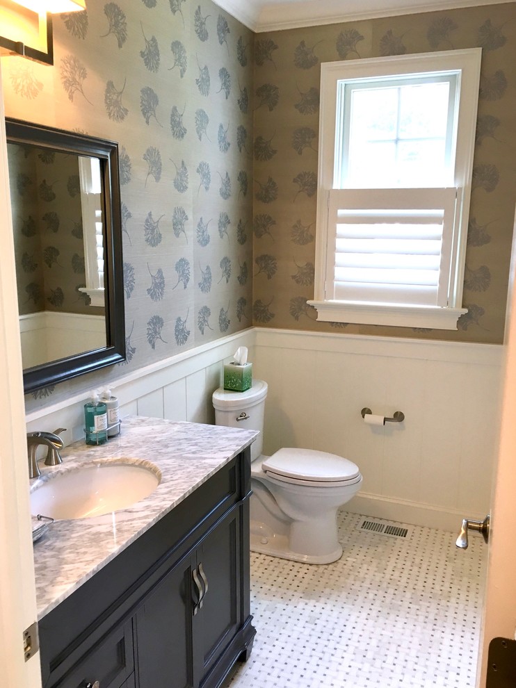 Design ideas for a medium sized classic cloakroom in Philadelphia with recessed-panel cabinets, black cabinets, a two-piece toilet, brown walls, mosaic tile flooring, a submerged sink, marble worktops and white floors.