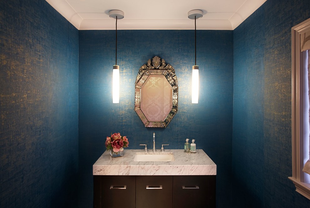 Mid-sized transitional powder room photo in New York with an undermount sink, flat-panel cabinets, dark wood cabinets, marble countertops and blue walls
