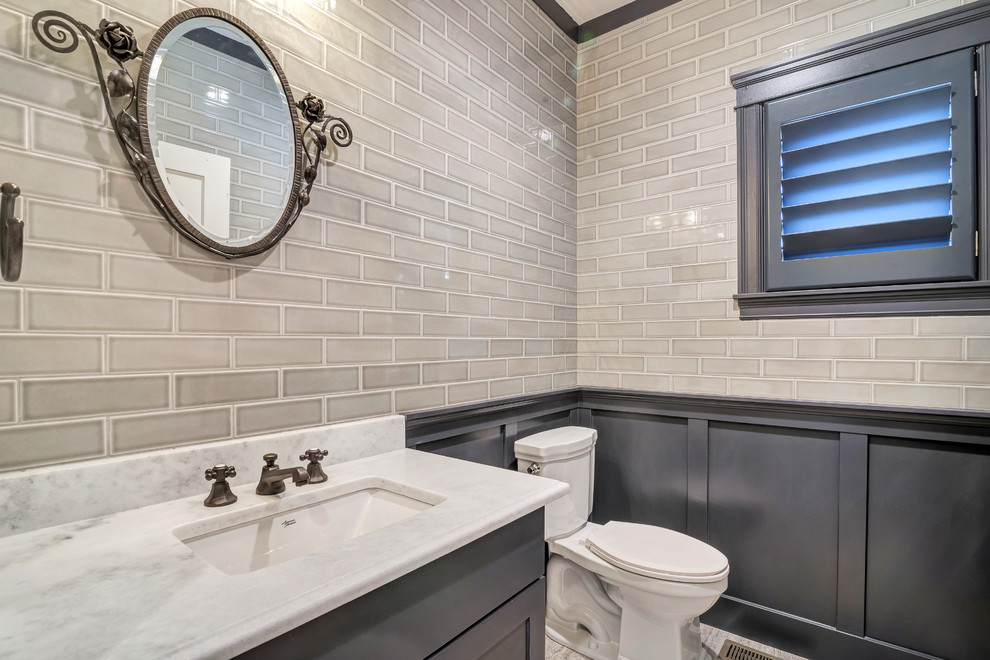 Powder room - small transitional beige tile and subway tile light wood floor and brown floor powder room idea in Salt Lake City with shaker cabinets, gray cabinets, a two-piece toilet, beige walls, an undermount sink, quartzite countertops and white countertops