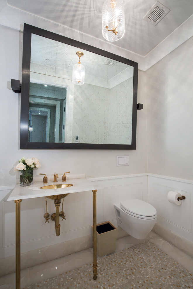 Cette image montre un WC suspendu traditionnel avec un mur beige, un plan vasque, un sol beige et un plan de toilette blanc.