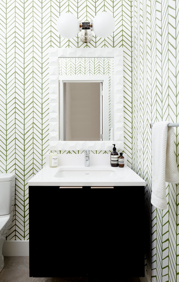 Example of a small trendy porcelain tile, gray floor and wallpaper powder room design in Philadelphia with flat-panel cabinets, brown cabinets, a one-piece toilet, white walls, an undermount sink, quartz countertops, white countertops and a floating vanity