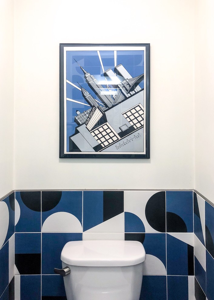 Example of a mid-sized trendy blue tile and cement tile dark wood floor and brown floor powder room design in New York with flat-panel cabinets, light wood cabinets, a bidet, white walls, a vessel sink, granite countertops and black countertops