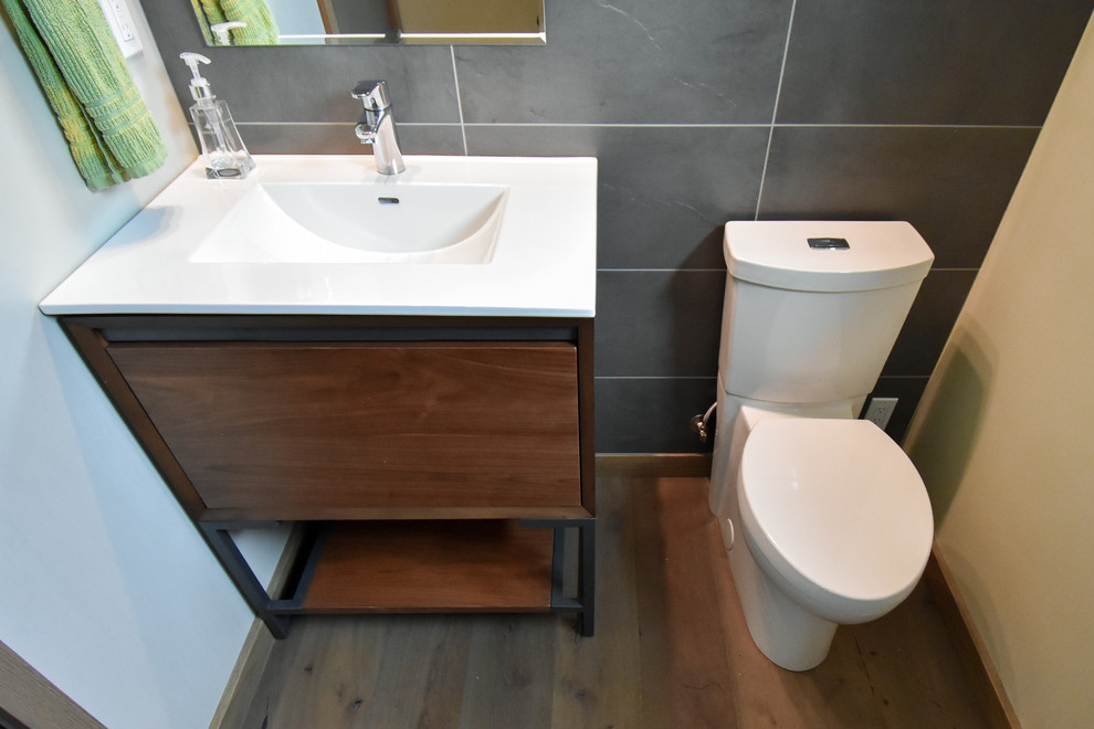 Inspiration pour un petit WC et toilettes minimaliste en bois foncé avec un placard à porte plane, WC séparés, un mur bleu, un lavabo de ferme, un carrelage noir et un sol en bois brun.
