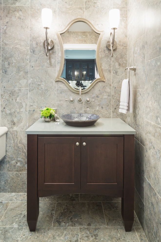 Inspiration for a small eclectic porcelain tile and gray tile porcelain tile powder room remodel in Providence with furniture-like cabinets, dark wood cabinets, a vessel sink and quartz countertops