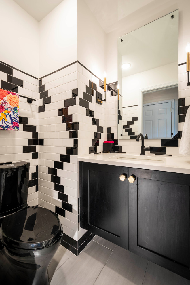 Small contemporary cloakroom in Indianapolis with shaker cabinets, black cabinets, a one-piece toilet, black and white tiles, ceramic tiles, white walls, porcelain flooring, a submerged sink, engineered stone worktops, grey floors, white worktops and a floating vanity unit.
