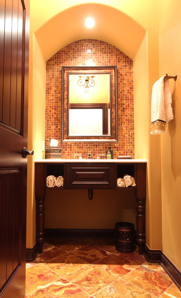 Cette photo montre un petit WC et toilettes chic en bois foncé avec un placard avec porte à panneau surélevé, WC séparés, un carrelage multicolore, un carrelage de pierre, un mur jaune, un sol en marbre, un lavabo encastré et un plan de toilette en quartz modifié.