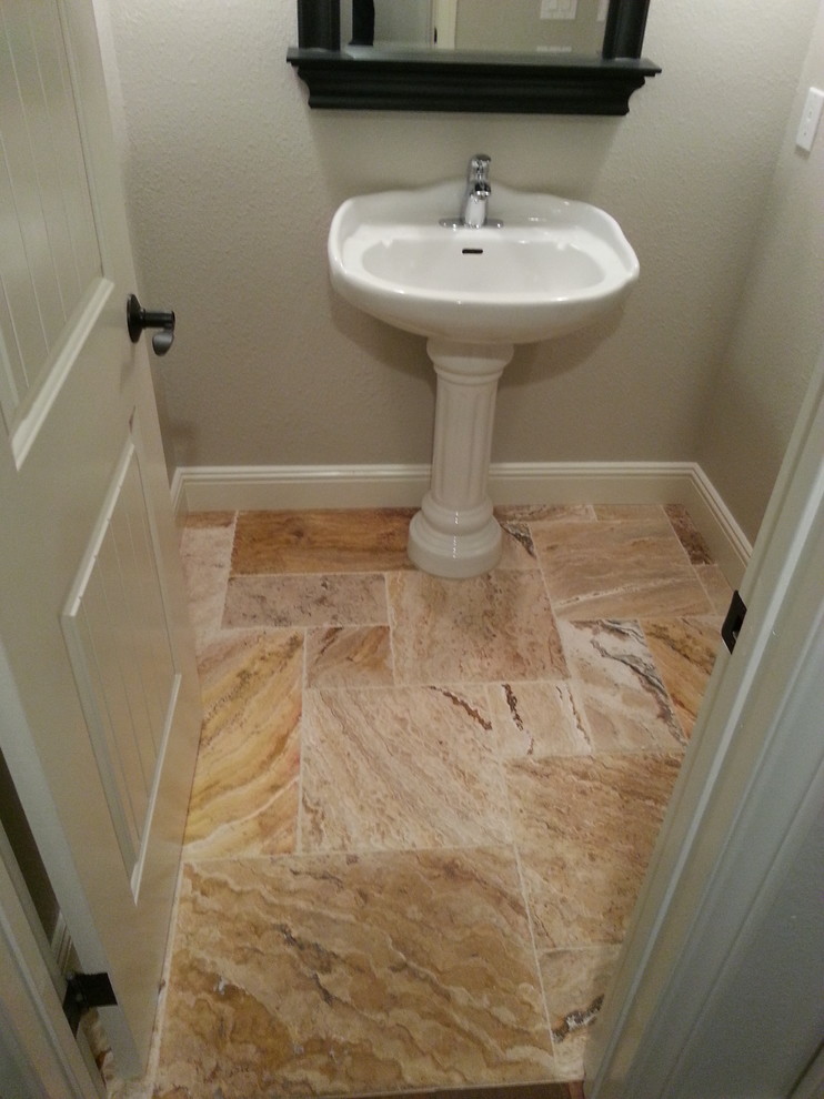 Small traditional cloakroom in Los Angeles with grey walls, limestone flooring, a pedestal sink, solid surface worktops and beige floors.