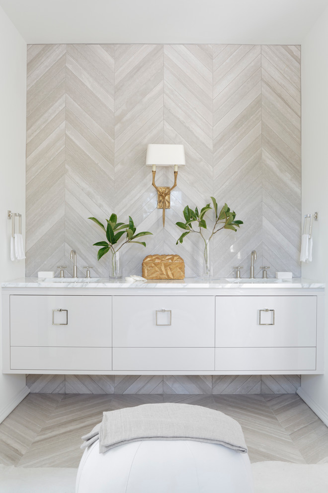 Example of a trendy powder room design in Atlanta with an undermount sink, marble countertops and beige walls