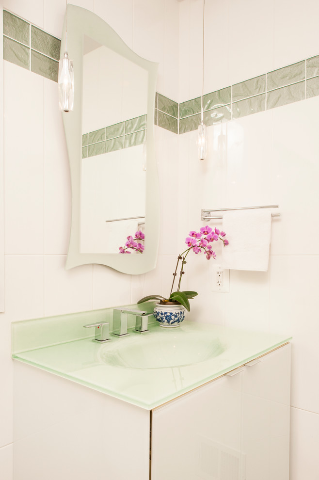 Photo of a small modern cloakroom in DC Metro with an integrated sink, glass-front cabinets, white cabinets, glass worktops, white tiles, glass tiles and white walls.