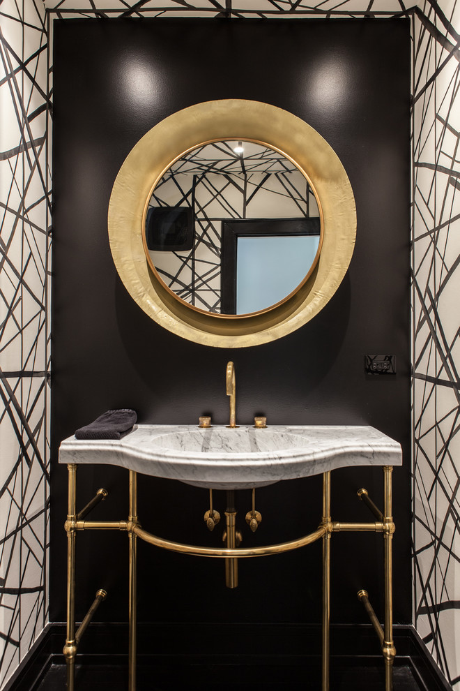 Inspiration for a mid-sized modern dark wood floor and black floor powder room remodel in Chicago with black walls, a console sink, marble countertops, white countertops and a wall-mount toilet