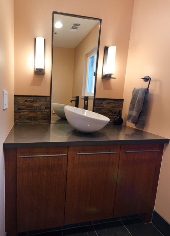 Example of a small trendy stone tile and gray tile slate floor powder room design in San Francisco with a vessel sink, flat-panel cabinets, quartz countertops, beige walls and dark wood cabinets