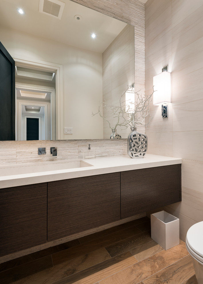 Inspiration for a mid-sized contemporary white tile ceramic tile powder room remodel in Toronto with an undermount sink, flat-panel cabinets, dark wood cabinets, quartzite countertops and white countertops