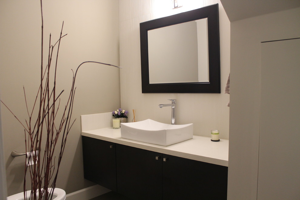 Inspiration for a small contemporary powder room remodel in San Francisco with flat-panel cabinets, dark wood cabinets, beige walls, a vessel sink and quartz countertops