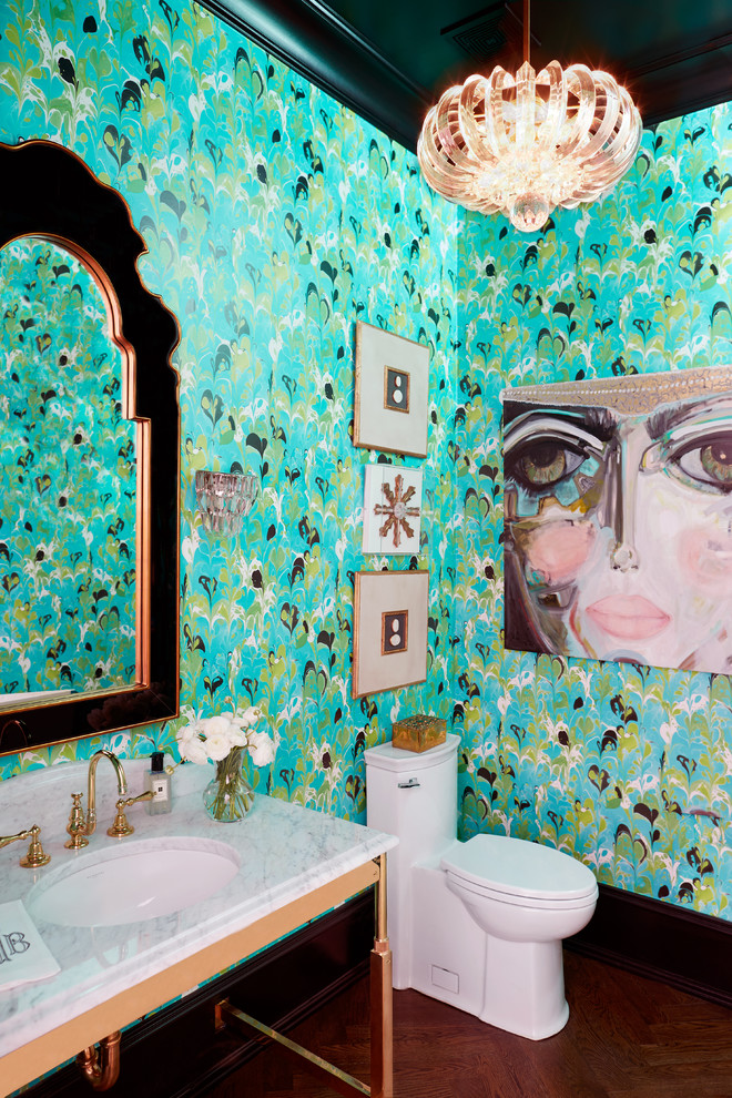 Powder room - eclectic medium tone wood floor and brown floor powder room idea in Raleigh with a one-piece toilet, blue walls, an undermount sink and white countertops