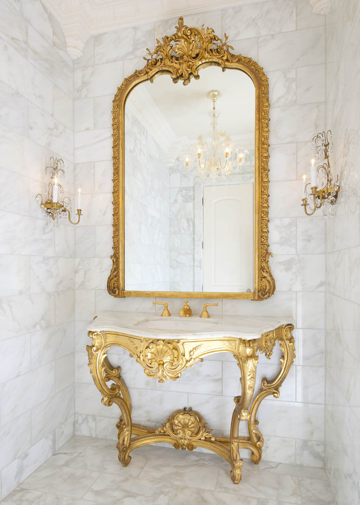 Elegant marble tile powder room photo in Dallas with an undermount sink