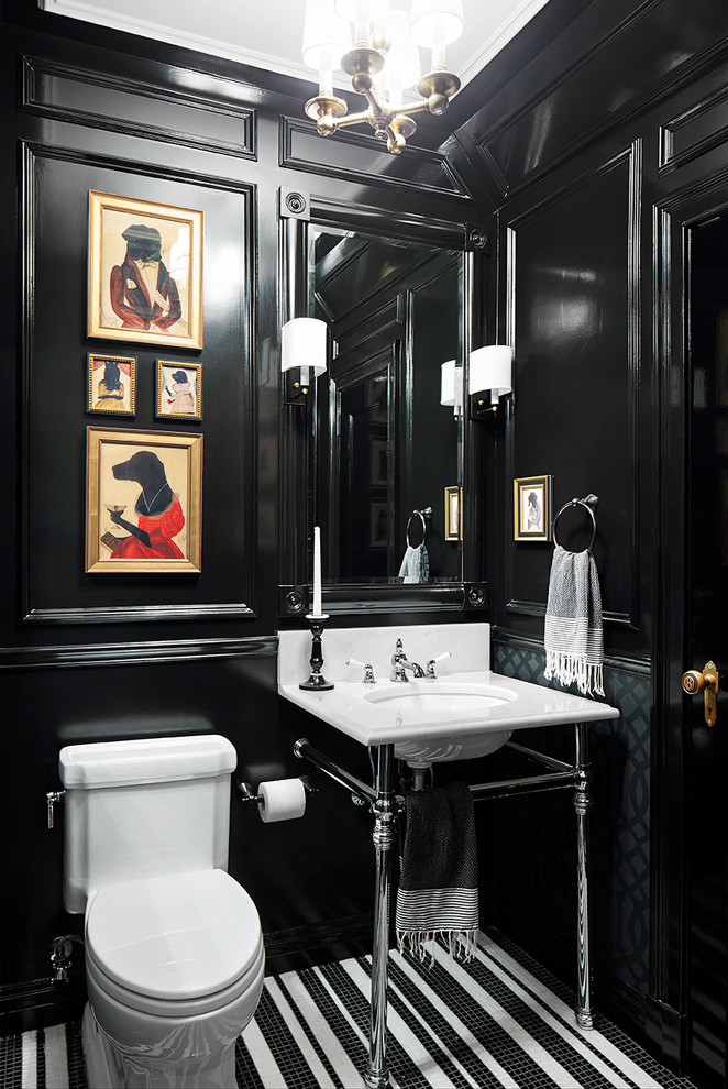 Elegant mosaic tile floor powder room photo in New York with a console sink, a one-piece toilet and black walls