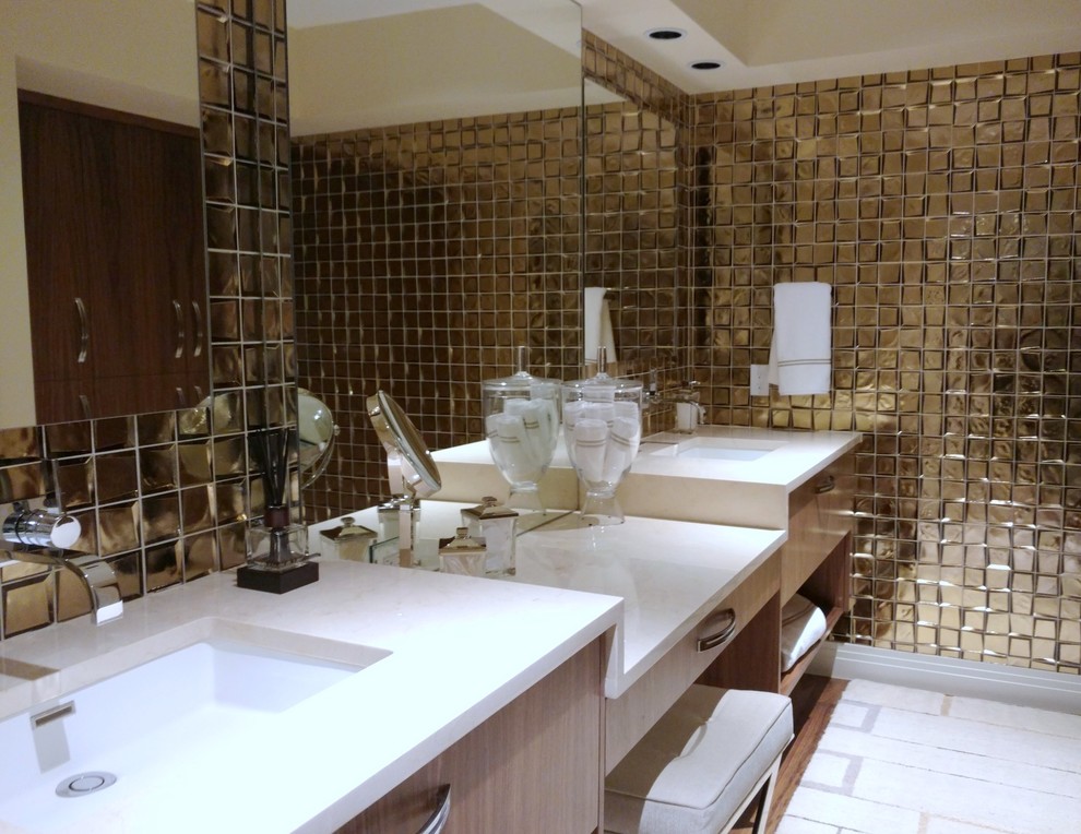 Powder room - mid-sized transitional glass tile medium tone wood floor powder room idea in Denver with flat-panel cabinets, medium tone wood cabinets, a one-piece toilet, beige walls, an undermount sink and marble countertops