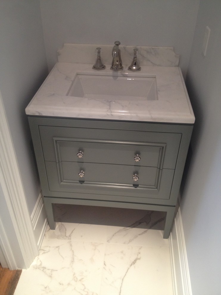 Imagen de aseo actual pequeño con lavabo bajoencimera, armarios tipo mueble, puertas de armario grises y encimera de mármol