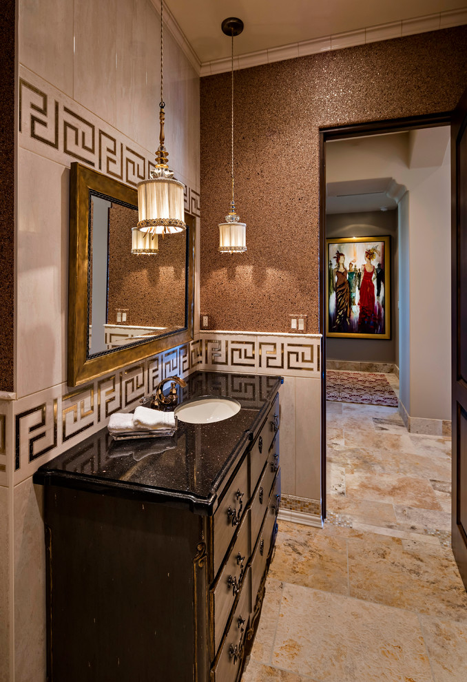 Example of a mid-sized tuscan black tile, white tile and stone tile ceramic tile powder room design in Phoenix with flat-panel cabinets, dark wood cabinets, a one-piece toilet, beige walls and an undermount sink