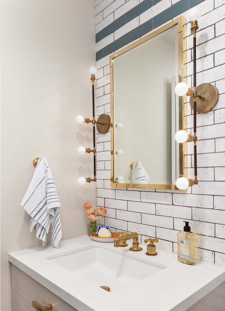 Powder room - mid-sized transitional white tile and subway tile powder room idea in New York with flat-panel cabinets, beige cabinets, beige walls, an undermount sink, quartz countertops and white countertops