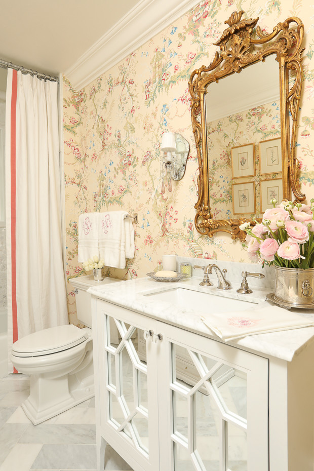Design ideas for a small traditional cloakroom in Atlanta with glass-front cabinets, white cabinets, a two-piece toilet, white tiles, pink walls, marble flooring, a submerged sink and marble worktops.
