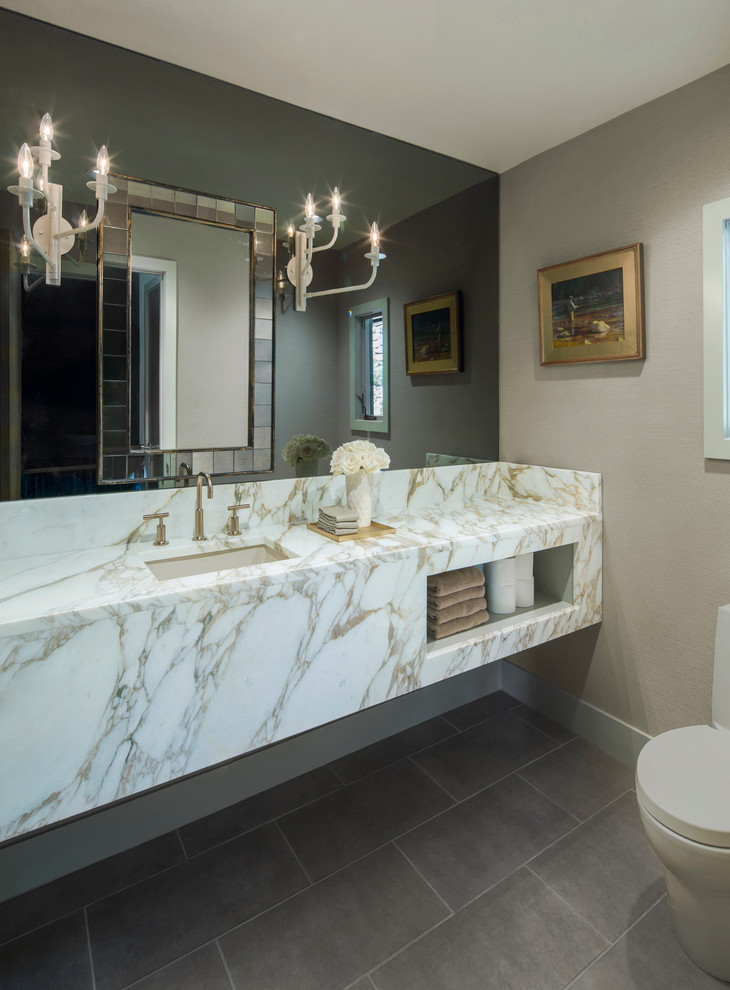 Example of a small trendy porcelain tile powder room design in Austin with an undermount sink, marble countertops, a one-piece toilet, beige walls and open cabinets
