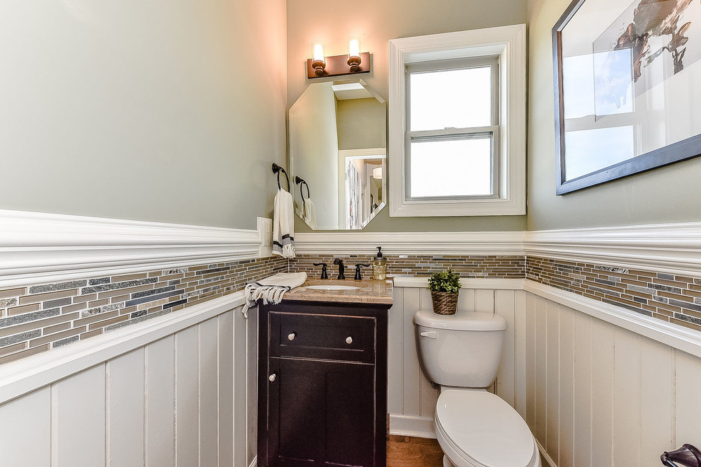 Inspiration for a mid-sized transitional multicolored tile and matchstick tile powder room remodel in Charlotte with recessed-panel cabinets, dark wood cabinets, green walls, a pedestal sink and quartzite countertops