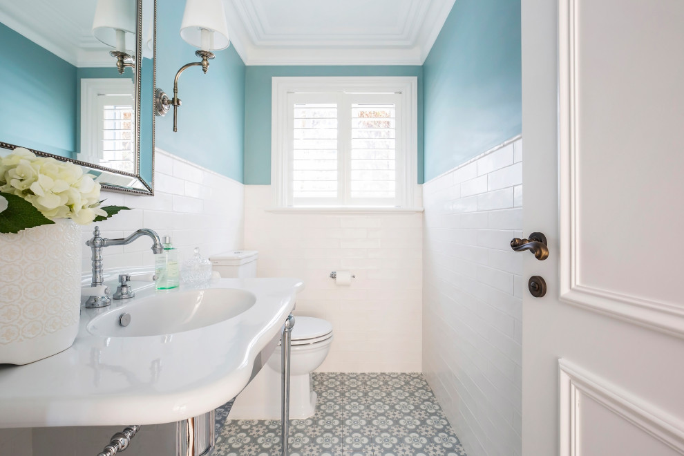 Traditional cloakroom in Sydney with white tiles, green walls, porcelain flooring and a pedestal sink.