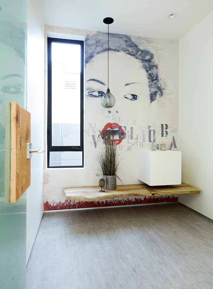 Powder room - contemporary powder room idea in Los Angeles with a wall-mount sink and white walls