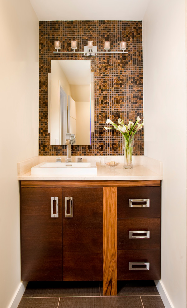 Design ideas for a small contemporary cloakroom in Boston with flat-panel cabinets, dark wood cabinets, black tiles, brown tiles, multi-coloured tiles, white walls, porcelain flooring, a built-in sink, solid surface worktops and mosaic tiles.