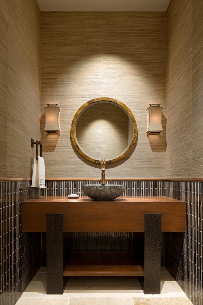 Powder room - contemporary brown tile and matchstick tile beige floor powder room idea in Miami with open cabinets, medium tone wood cabinets, brown walls and a vessel sink