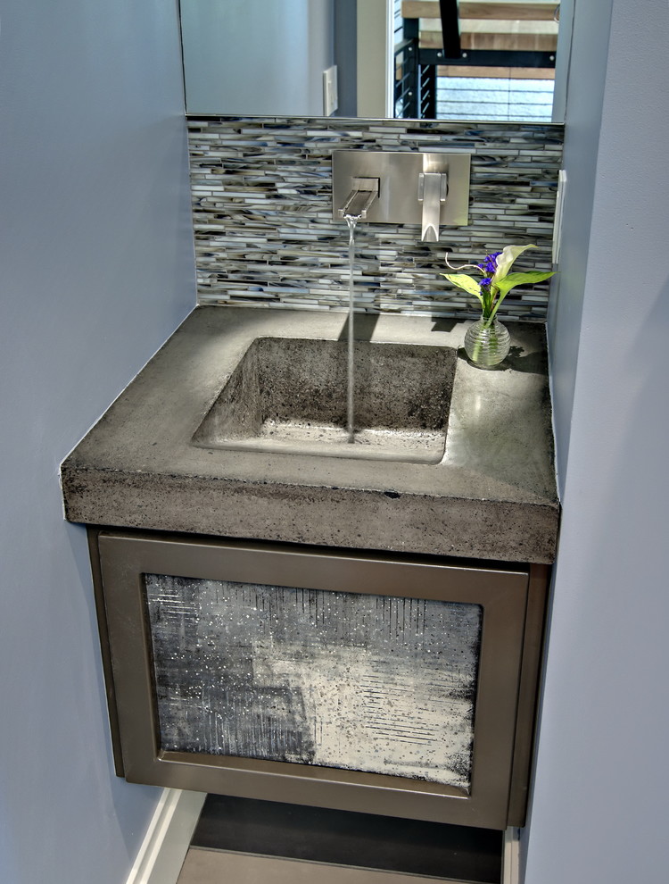 Inspiration for a small contemporary cloakroom in Minneapolis with flat-panel cabinets, grey cabinets, a two-piece toilet, black tiles, blue tiles, grey tiles, white tiles, matchstick tiles, blue walls, porcelain flooring, an integrated sink, concrete worktops, multi-coloured floors and grey worktops.