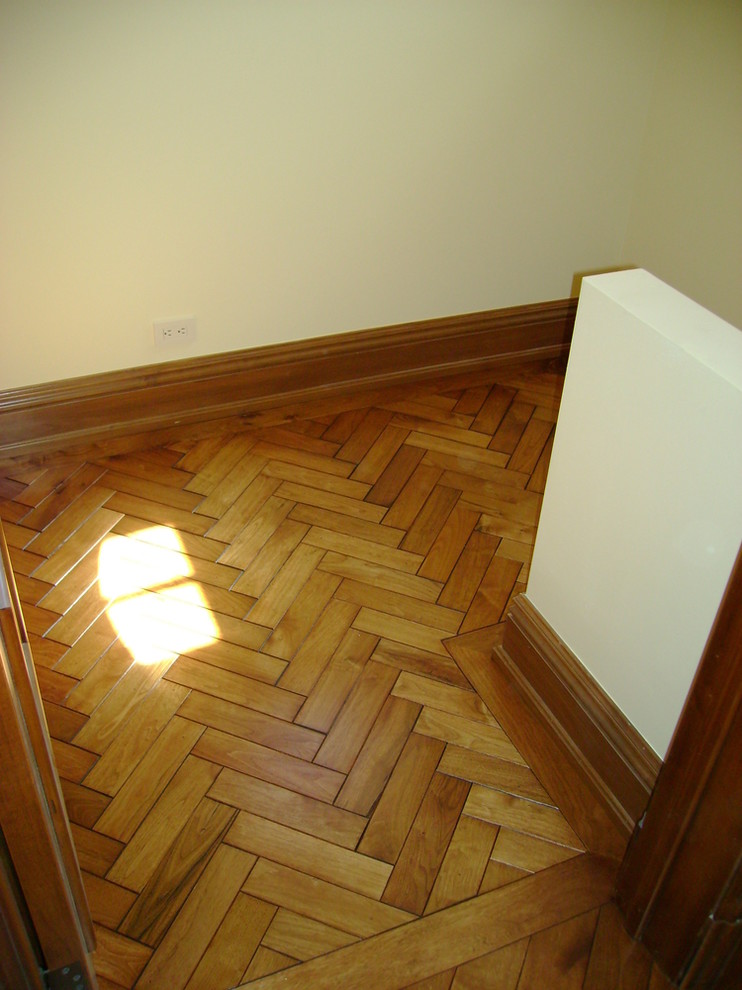 Photo of a small cloakroom in Minneapolis with medium hardwood flooring and beige walls.