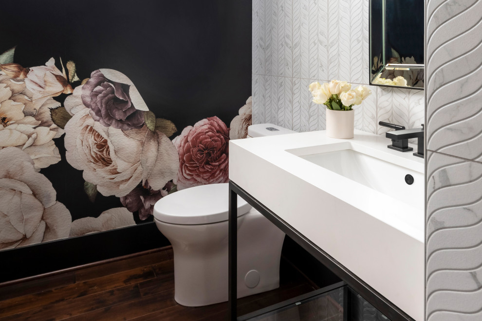 Photo of a small contemporary cloakroom in Seattle with black cabinets, a one-piece toilet, white tiles, porcelain tiles, black walls, dark hardwood flooring, a console sink, marble worktops, white worktops, a freestanding vanity unit and wallpapered walls.