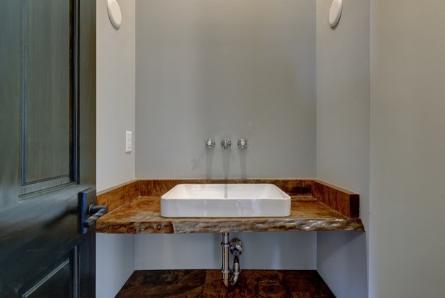 Mittelgroße Urige Gästetoilette mit grauer Wandfarbe, braunem Holzboden, Einbauwaschbecken und braunem Boden in Sonstige
