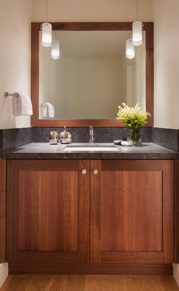 This is an example of a medium sized traditional cloakroom in San Francisco with shaker cabinets, dark wood cabinets, a one-piece toilet, grey tiles, stone slabs, white walls, a submerged sink, granite worktops, brown floors and light hardwood flooring.