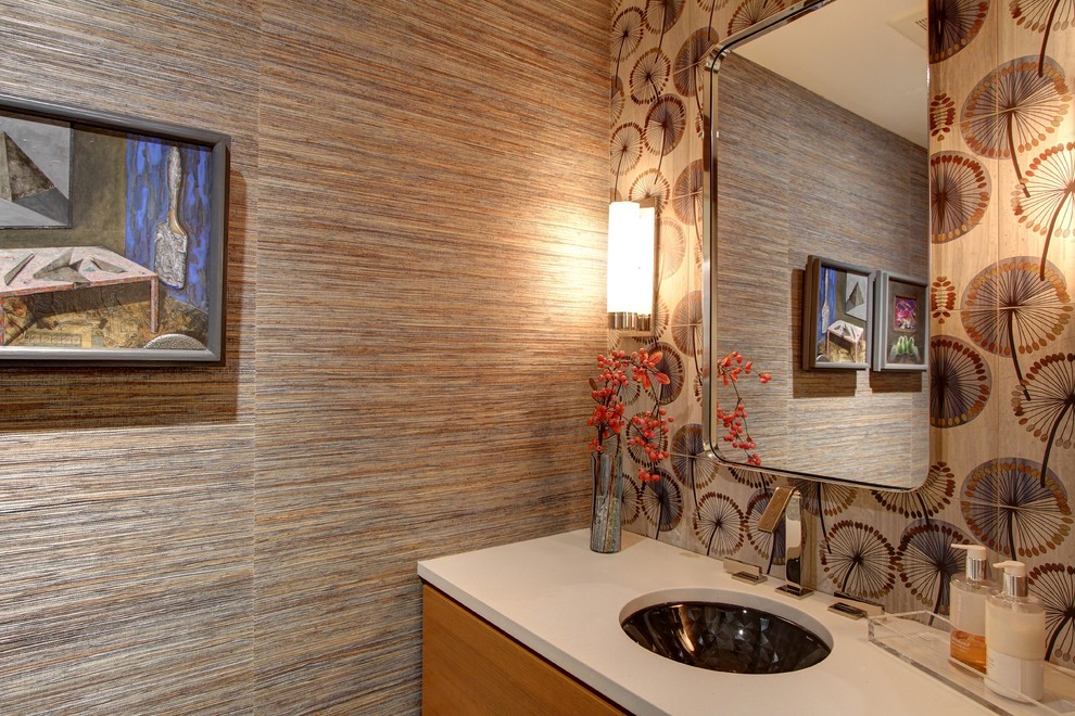 Powder room - mid-sized transitional powder room idea in Denver with flat-panel cabinets, light wood cabinets, an undermount sink, concrete countertops and white countertops