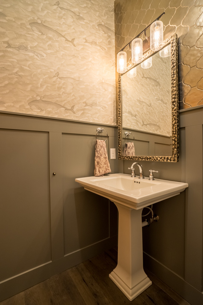 Medium sized classic cloakroom in Seattle with a one-piece toilet, beige tiles, metal tiles, beige walls, dark hardwood flooring, a pedestal sink, solid surface worktops, brown floors and white worktops.