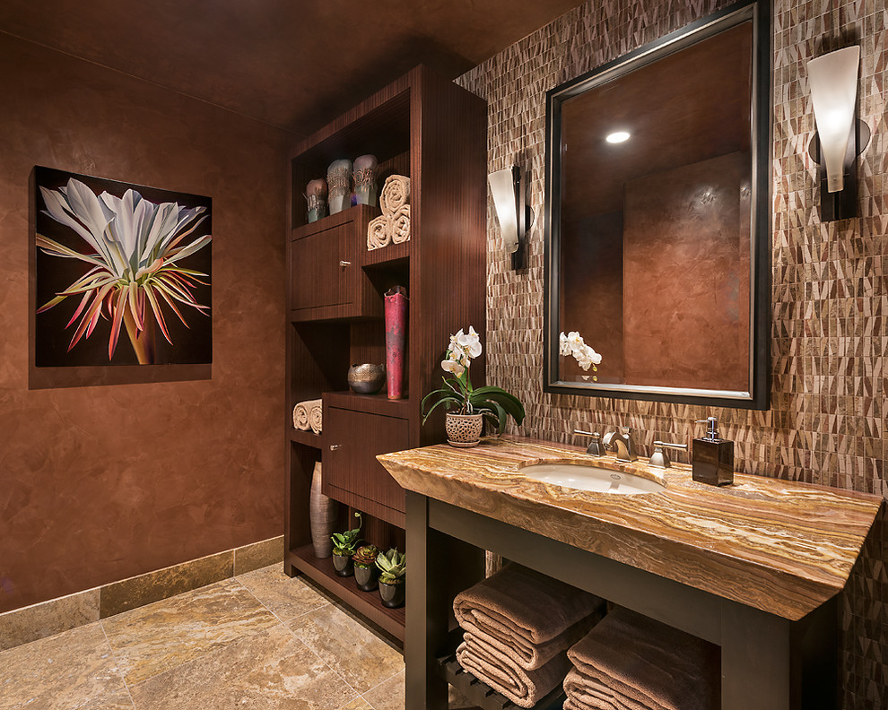 Photo of a large contemporary cloakroom in Other with stone tiles, multi-coloured walls, travertine flooring, a submerged sink, onyx worktops, flat-panel cabinets, dark wood cabinets and multi-coloured tiles.