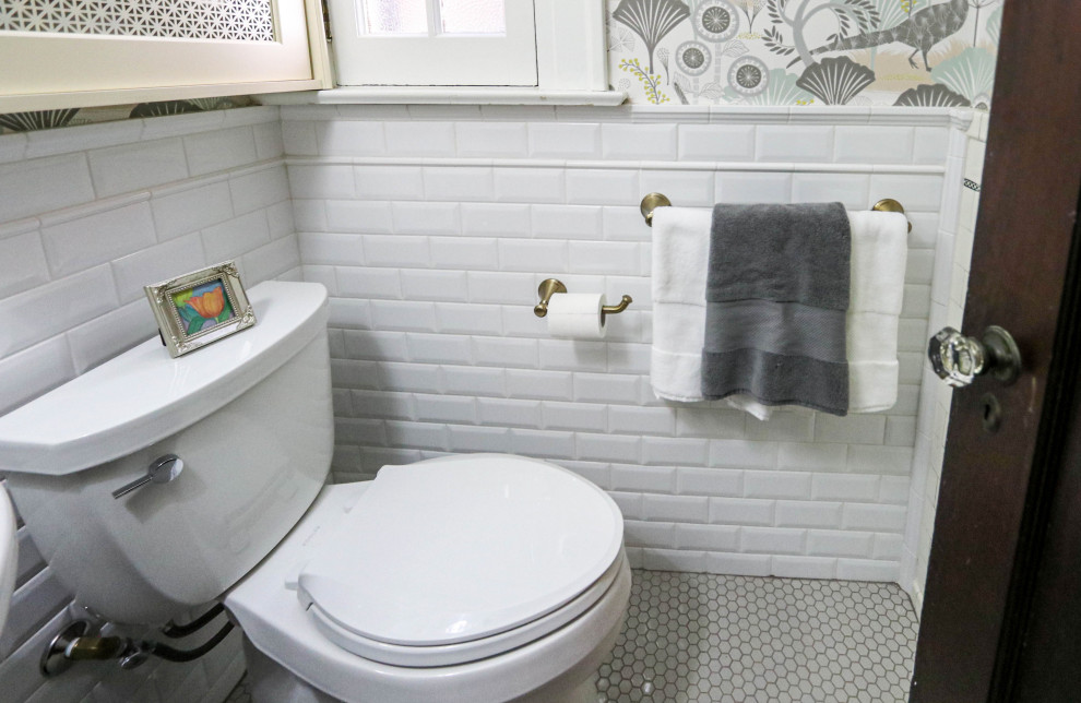Small classic cloakroom in Cleveland with a two-piece toilet, white tiles, ceramic tiles, multi-coloured walls, ceramic flooring, a pedestal sink, grey floors and wallpapered walls.