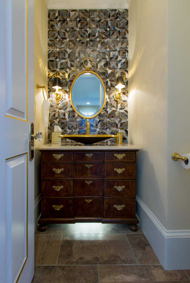 This is an example of a medium sized classic cloakroom in DC Metro with flat-panel cabinets, dark wood cabinets, beige tiles, brown tiles, grey tiles, multi-coloured tiles, white tiles, marble tiles, beige walls, a vessel sink and brown floors.