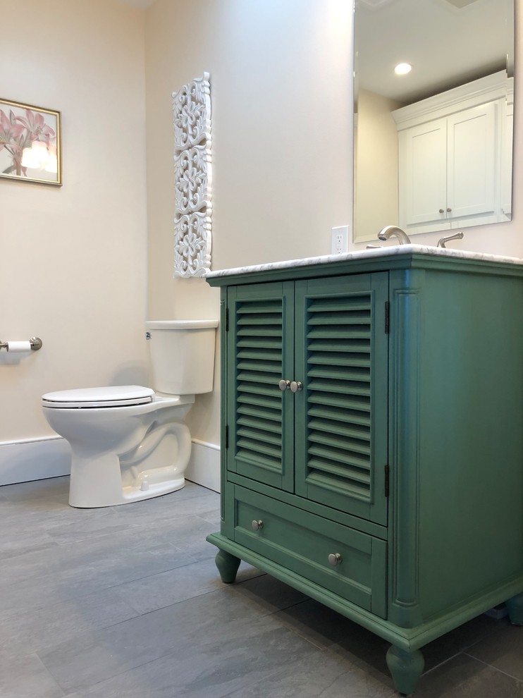 Design ideas for a medium sized rural cloakroom in Philadelphia with louvered cabinets, green cabinets, a two-piece toilet, white walls, ceramic flooring, a submerged sink, marble worktops, grey floors and white worktops.