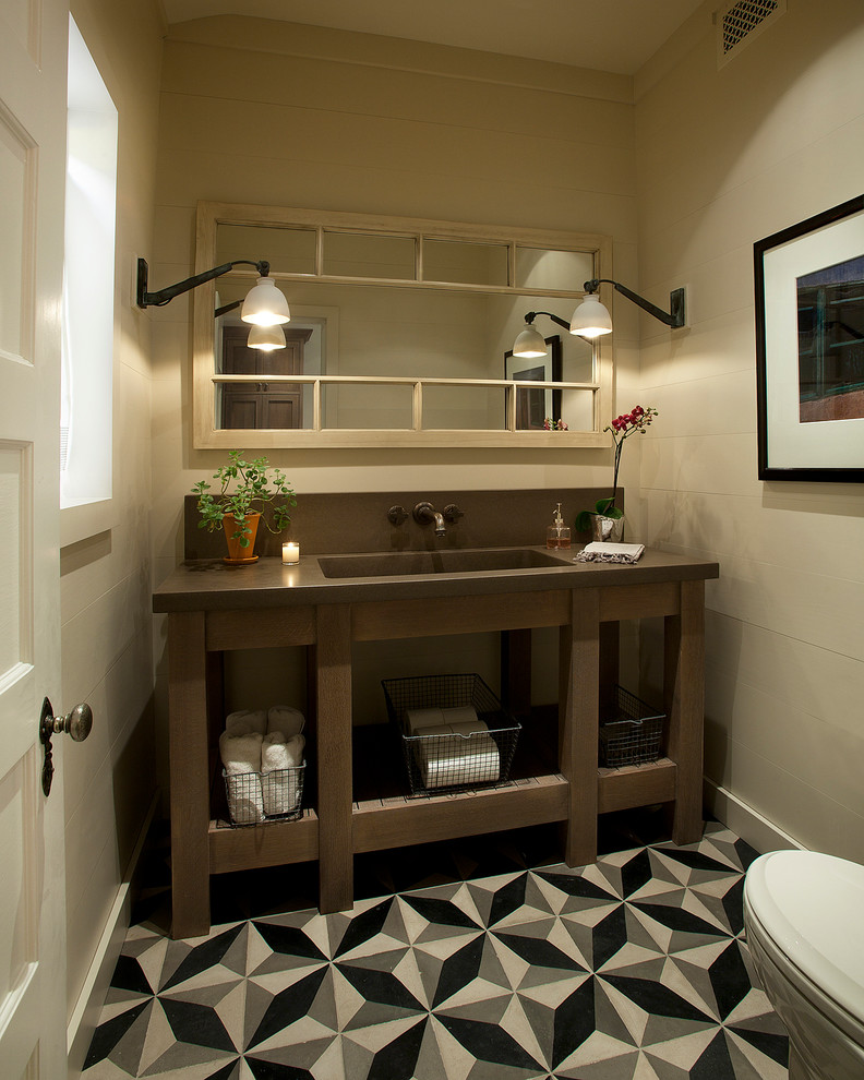 Example of a classic powder room design in Phoenix with an integrated sink, open cabinets, dark wood cabinets, beige walls and brown countertops