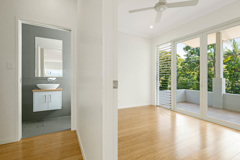 Kleine Moderne Gästetoilette mit Waschtisch aus Holz, grauen Fliesen, Keramikfliesen, weißen Schränken und flächenbündigen Schrankfronten in Cairns