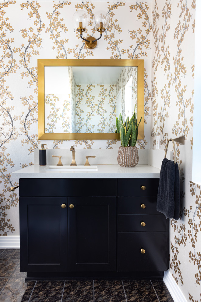 Mid-sized transitional ceramic tile, black floor and wallpaper powder room photo in Los Angeles with shaker cabinets, black cabinets, a two-piece toilet, a drop-in sink, quartz countertops, white countertops and a built-in vanity
